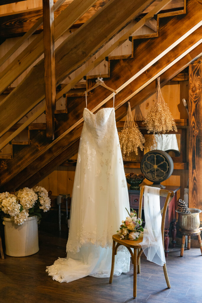 Detail shot of a wedding gown hanging in the bridal suite at Lochwood Manor, a barn venue in Skippack, PA