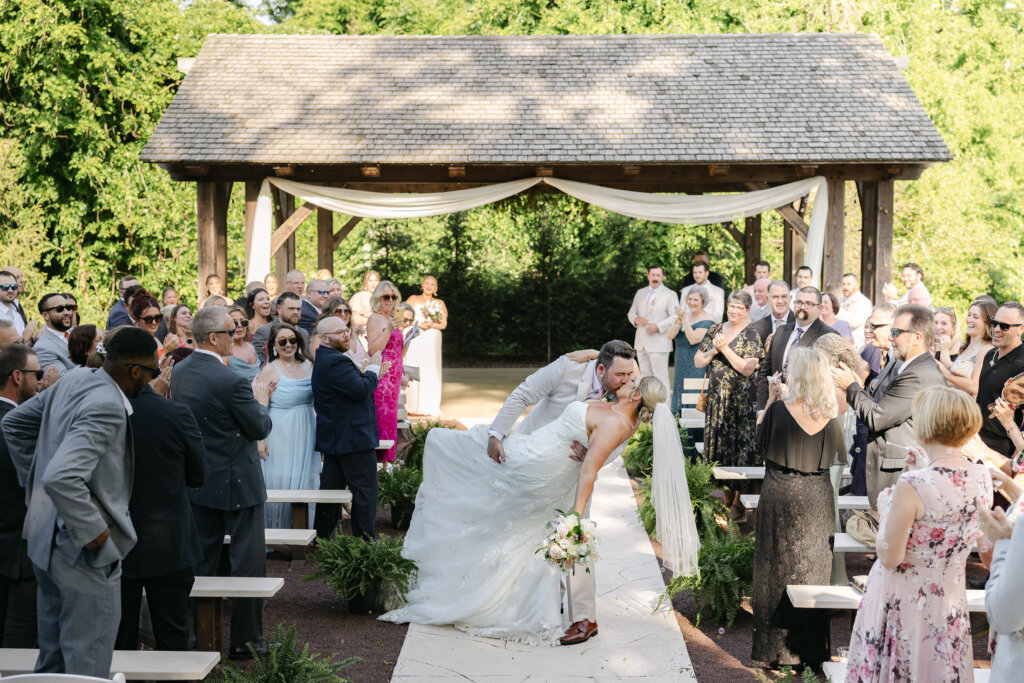Kiss at the end of wedding ceremony at Lochwood Manor, barn venue in Skippack PA