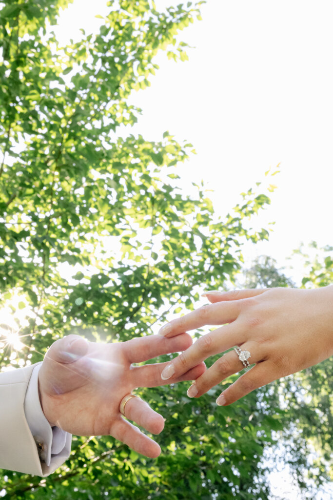 Newlywed hands touching with engagement rings showing
