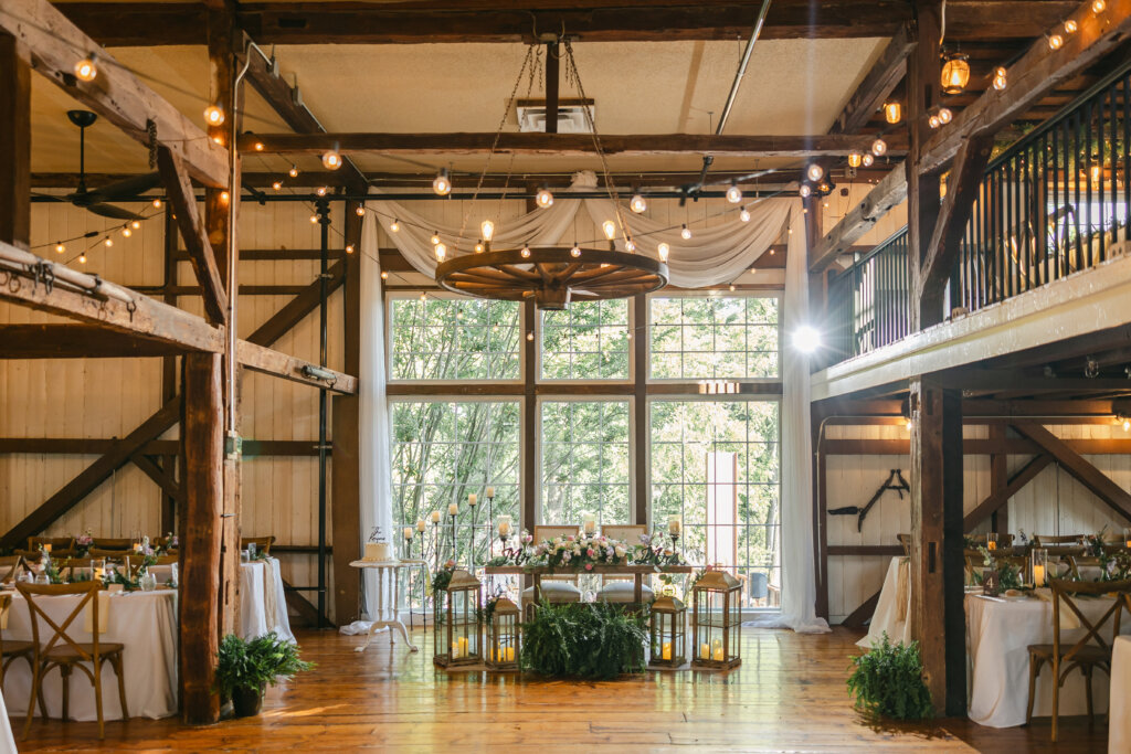Reception tables in barn ballroom for wedding at Lochwood Manor