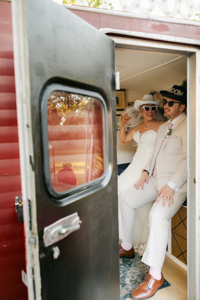 Bride and groom in photo booth at barn wedding venue Lochwood Manor